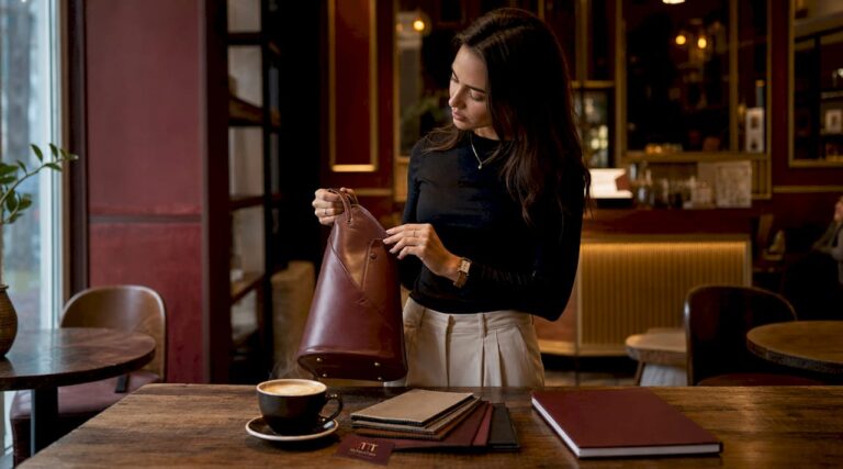 Woman examining handbag in curated boutique