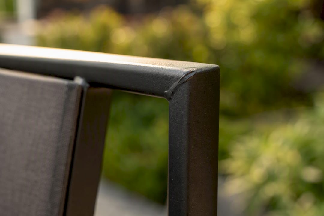 Powder-coated steel frame corner close-up on outdoor chair
