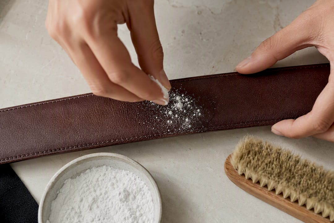 Cornstarch absorbing grease from leather strap